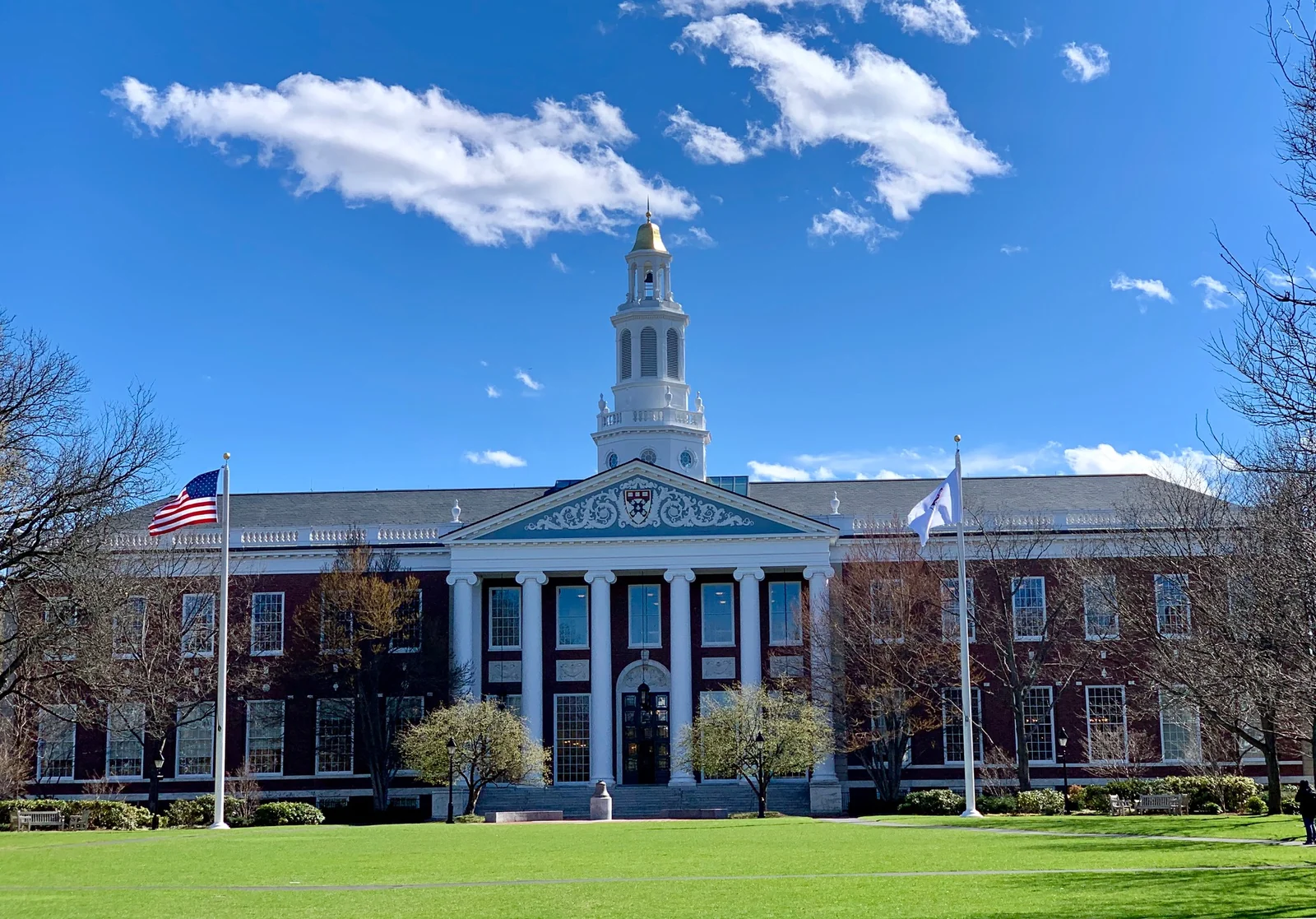 Baker Library at Harvard Business School, with its tower, lawn and blue sky